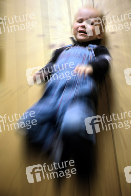 Weinender Junge auf Holzfußboden