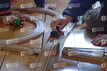 Spielzeugeisenbahn und Kinderhände