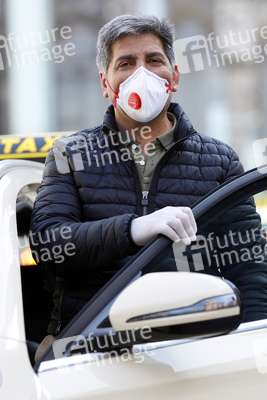Symbolfoto Taxifahrer mit Schutzkleidung