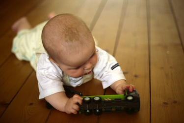 Baby mit Spielzeuglaster