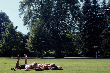 Zwei Frauen relaxen auf einer Parkwiese