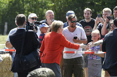 Angela Merkel besucht einen Milchbauernhof in Nienborstel